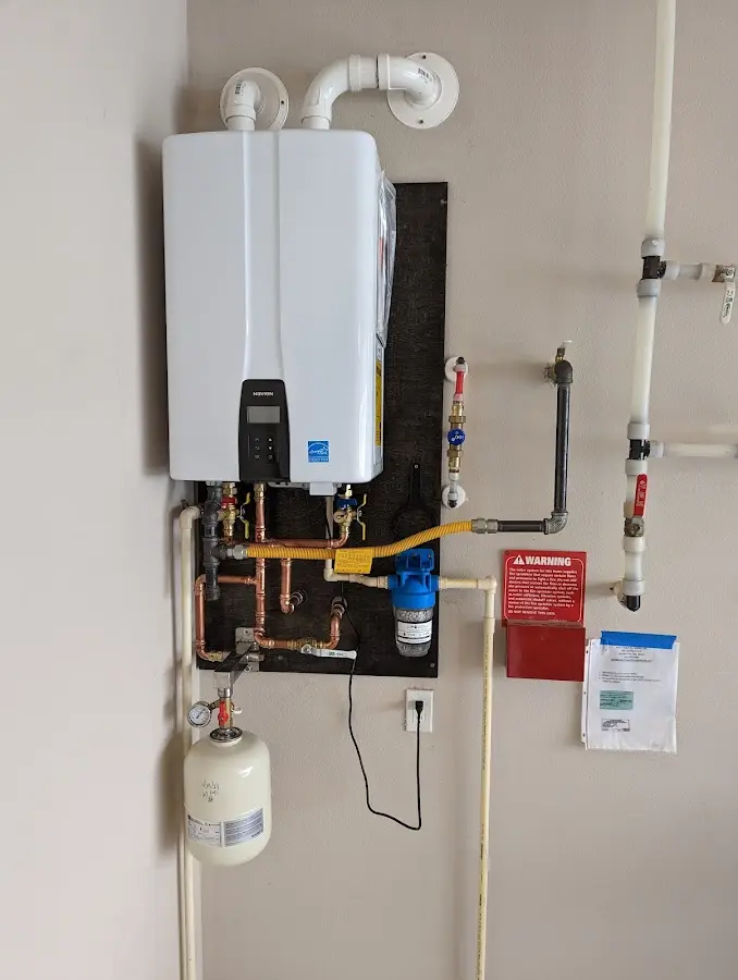 Professional plumber installing copper piping in a Wayzata home